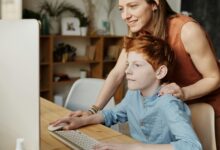 Woman and child behind a computer