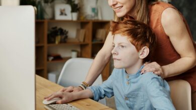 Woman and child behind a computer